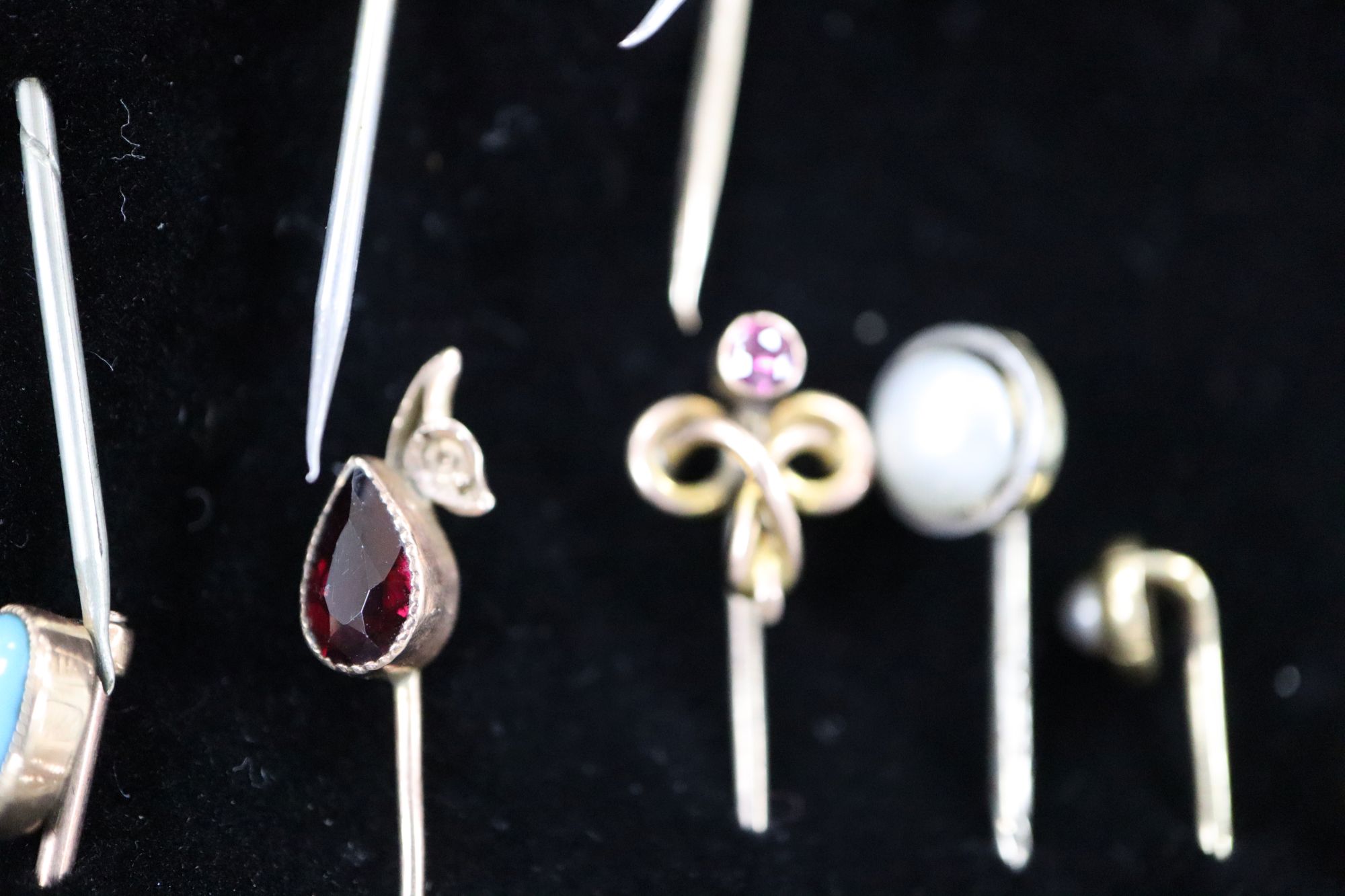 Twenty assorted Victorian and later mainly yellow metal and gem set stick pins